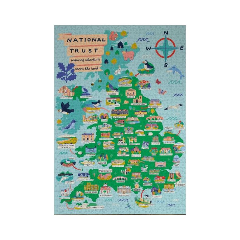 Completed National Trust 500-piece jigsaw puzzle featuring a colourful illustrated map of the United Kingdom, highlighting iconic National Trust locations, historic houses, gardens, coastlines and wildlife. Detailed artwork includes labelled landmarks, na