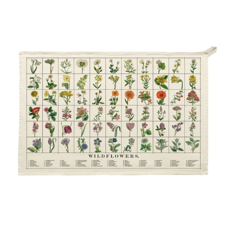 Organic cotton tea towel featuring an illustrated wildflowers chart with colourful botanical drawings arranged in a grid. The natural cream fabric includes a hanging loop and printed flower names, showcasing a vintage-inspired botanical design against a p