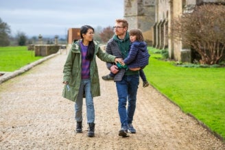 Gift membership - celebrate a birthday, anniversary or special moment with a gift membership from the National Trust. Image shows adult and child exploring the outdoors together, with trees and foliage in the background.  