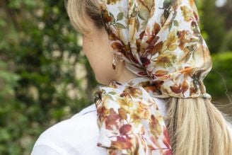 Scarves - image shows model wearing the Hinton Ampner inspired scarf from the new National Trust autumn winter range.