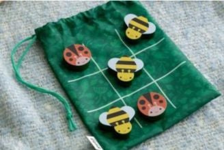 Children's games - image shows selection of toys and games from the National Trust children's range, including Squirrel Jump the board game, Jellycat soft toys Conker and Acorn, as well as the Match a Tree card game and Woodland Dominoes.