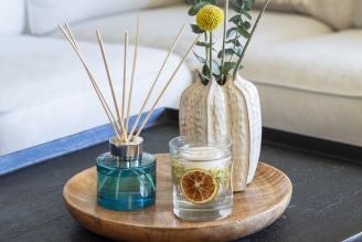 Home fragrance - image shows the Coffee and Bergamot Reed Diffuser on a windowsill, with a soft light shining through the window and illuminating the retro, vintage inspired glass bottle.